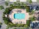 Overhead shot of the community pool and sundeck, complete with chairs and lush greenery at 4103 Foristall Ave # 4103, Sarasota, FL 34233