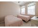 Bright bedroom with two twin beds, soft lighting, and a calming atmosphere at 4103 Foristall Ave # 4103, Sarasota, FL 34233