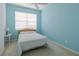 Airy bedroom with blue accent wall, large window and plush carpeting at 4103 Foristall Ave # 4103, Sarasota, FL 34233