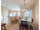 Bright dining area featuring a kitchen bar and a view of the kitchen appliances at 4103 Foristall Ave # 4103, Sarasota, FL 34233