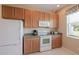 Bright kitchen features updated appliances, light wood cabinets and window view to the backyard at 4103 Foristall Ave # 4103, Sarasota, FL 34233