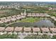 Aerial view showing the community's layout with pond, buildings, parking and surrounding areas at 4254 Vicenza Dr # B, Venice, FL 34293