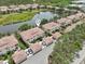 Aerial view of complex, showcasing the pond, terracotta rooftops, and well-maintained landscaping at 4254 Vicenza Dr # B, Venice, FL 34293