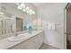 Well-lit bathroom featuring double sinks, a large mirror, and modern fixtures at 4254 Vicenza Dr # B, Venice, FL 34293
