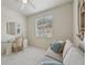 Bright bedroom featuring a ceiling fan, a sofa bed and a quaint desk area by the window at 4254 Vicenza Dr # B, Venice, FL 34293