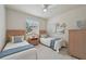 Comfortable bedroom with twin beds, a ceiling fan, and bright natural light at 4254 Vicenza Dr # B, Venice, FL 34293
