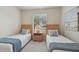 Bright bedroom featuring two twin beds, a nightstand, and a window with natural light at 4254 Vicenza Dr # B, Venice, FL 34293