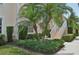 Two-story condo unit with trimmed hedges, manicured lawn, and stairway at 4254 Vicenza Dr # B, Venice, FL 34293