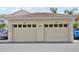 Two-car garage with tile roof features individual doors marked 'B' and 'D' with address at 4254 Vicenza Dr # B, Venice, FL 34293