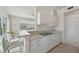Bright kitchen featuring white cabinets, bar seating, and view to the living area at 4254 Vicenza Dr # B, Venice, FL 34293
