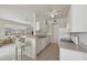 Open-concept kitchen with white cabinets, bar seating, and view into the living area at 4254 Vicenza Dr # B, Venice, FL 34293