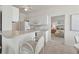 Well-lit kitchen with white cabinetry, modern appliances, and bar-top seating at 4254 Vicenza Dr # B, Venice, FL 34293