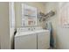 Functional laundry room with a full-size washer, dryer and built-in shelving at 4254 Vicenza Dr # B, Venice, FL 34293