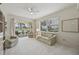 Bright living room with large sliding glass doors opening to pond view in neutral color scheme at 4254 Vicenza Dr # B, Venice, FL 34293