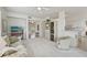 Open-concept living room with an island bar to the kitchen and bright lighting, with an adjacent hall at 4254 Vicenza Dr # B, Venice, FL 34293