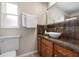 Bathroom with granite vanity, white vessel sink, and tiled backsplash at 4405 Linwood St, Sarasota, FL 34232