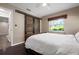 Bright bedroom features a sliding barn door closet and a large window overlooking the outdoor landscape at 4405 Linwood St, Sarasota, FL 34232
