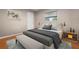 Neutral toned bedroom with bench, end tables, and an upholstered headboard at 4405 Linwood St, Sarasota, FL 34232