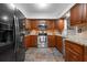 Kitchen with stainless steel appliances, granite countertops, and dark wood cabinets at 4405 Linwood St, Sarasota, FL 34232