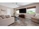 Cozy living room with natural light, tiled floors, ceiling fan and neutral decor at 4405 Linwood St, Sarasota, FL 34232