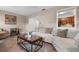 Cozy living room featuring a comfortable sofa, stylish coffee table, and a glimpse into the modern kitchen at 4405 Linwood St, Sarasota, FL 34232