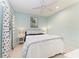 Bedroom with light blue walls, white curtains, and a comfortable queen bed at 4416 Amalfi Ave, Sarasota, FL 34243