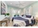 Bedroom with light blue walls, white curtains, and a comfortable queen bed at 4416 Amalfi Ave, Sarasota, FL 34243