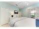 Bedroom with light blue walls, TV, and a comfortable queen bed at 4416 Amalfi Ave, Sarasota, FL 34243
