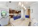 Open dining room with wooden table, view to the modern kitchen, and a comfy seating area at 4416 Amalfi Ave, Sarasota, FL 34243