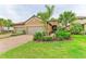 Charming single-story home with lush landscaping, mature palms, and a two-car garage at 4416 Amalfi Ave, Sarasota, FL 34243