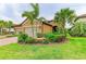 Charming single-story home with lush landscaping, mature palms, and a two-car garage at 4416 Amalfi Ave, Sarasota, FL 34243