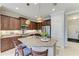 Well-equipped kitchen features granite counters, stainless steel appliances, and a large island with seating at 4416 Amalfi Ave, Sarasota, FL 34243