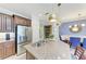 This kitchen boasts granite countertops, stainless steel appliances, and stylish pendant lighting at 4416 Amalfi Ave, Sarasota, FL 34243
