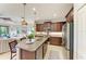 Gourmet kitchen with stainless appliances, granite island, and open floor plan to the living room at 4416 Amalfi Ave, Sarasota, FL 34243