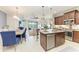 Open-concept kitchen with stainless steel appliances, granite countertops, and a center island at 4416 Amalfi Ave, Sarasota, FL 34243