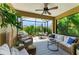 Inviting screened lanai featuring comfortable wicker seating, a ceiling fan, and views of the lush backyard at 4416 Amalfi Ave, Sarasota, FL 34243