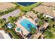 Aerial shot of a resort-style pool area, complete with lounge chairs, cabanas, and well-maintained landscaping at 4416 Amalfi Ave, Sarasota, FL 34243