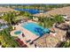 Overhead view of the community pool area, featuring a jacuzzi, lounge chairs, and palm trees at 4416 Amalfi Ave, Sarasota, FL 34243