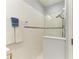Shower featuring white tile, glass partition, and a dual shower head at 4416 Amalfi Ave, Sarasota, FL 34243