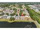 Aerial view of the house featuring a pool and pond, surrounded by neighborhood homes at 4627 56Th E Dr, Bradenton, FL 34203