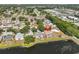 Aerial view of the house with a pool and pond, nestled within a vibrant community at 4627 56Th E Dr, Bradenton, FL 34203