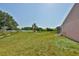 Spacious lawn, screened pool, and scenic lake views beyond at 4627 56Th E Dr, Bradenton, FL 34203