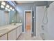Bathroom featuring a double vanity, tiled floors, shower and bath combination, and access to the bedroom at 4627 56Th E Dr, Bradenton, FL 34203