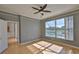 Bright bedroom with a ceiling fan, wood floors, crown molding and views of the screened in lanai and pool at 4627 56Th E Dr, Bradenton, FL 34203