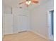 Well-lit bedroom with wood floors, ceiling fan, access to a bathroom, and closet for storage at 4627 56Th E Dr, Bradenton, FL 34203