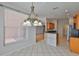Cozy dining area with a chandelier, tile flooring, and natural light from the window at 4627 56Th E Dr, Bradenton, FL 34203