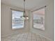Bright dining area features tile flooring, two windows and a view of the lanai and pool at 4627 56Th E Dr, Bradenton, FL 34203