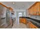 Well-appointed kitchen with stainless steel appliances, granite countertops, and wood cabinetry at 4627 56Th E Dr, Bradenton, FL 34203