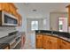 Stylish kitchen with stainless steel appliances, granite countertops, and open layout to dining area at 4627 56Th E Dr, Bradenton, FL 34203