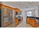 Well-lit kitchen features stainless steel appliances, wood cabinetry, and granite countertops at 4627 56Th E Dr, Bradenton, FL 34203